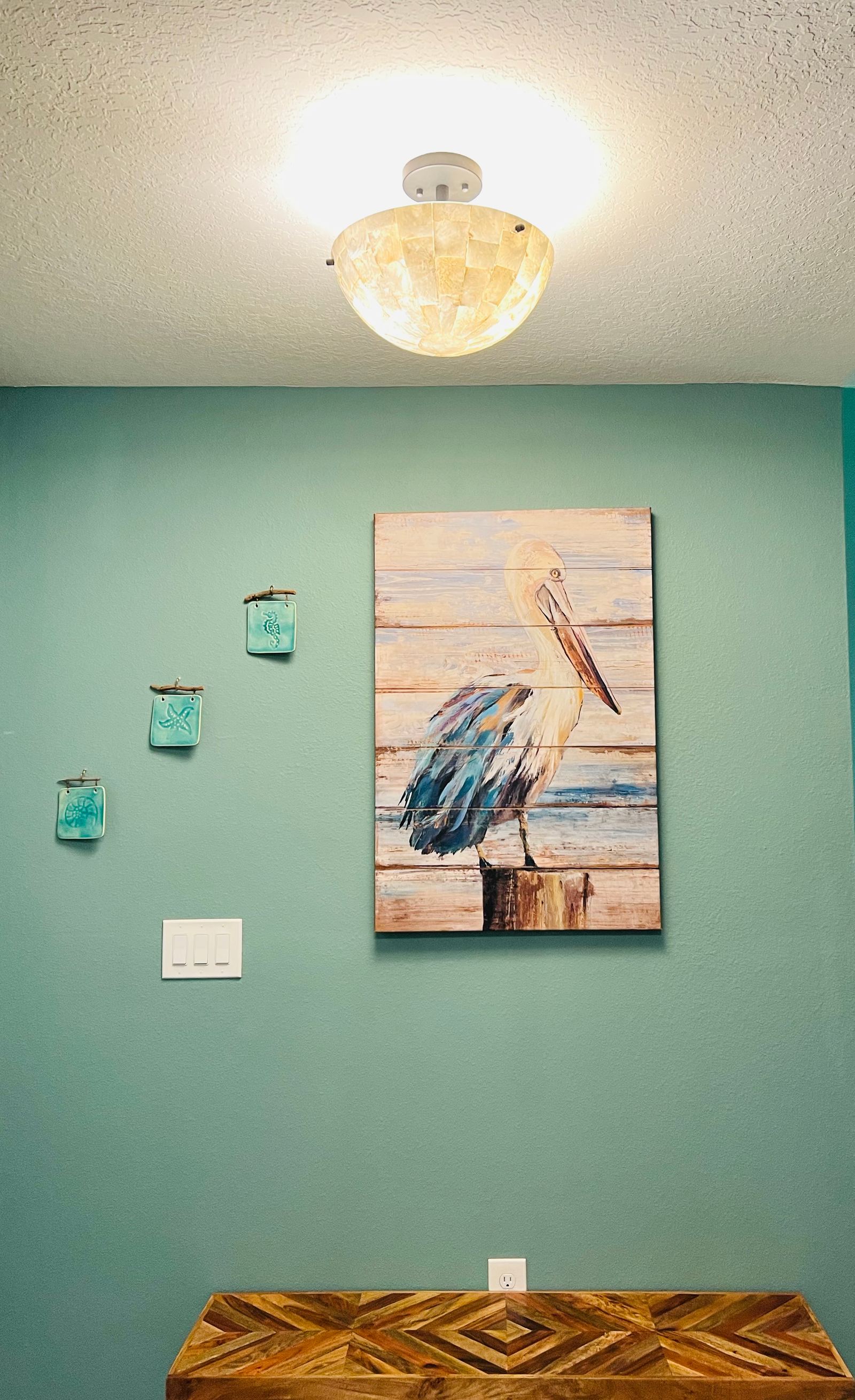 Freshly painted accent wall with coastal artwork in a Palm Coast home